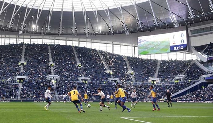 What are football clubs doing to reduce single-use plastic in their stadiums?